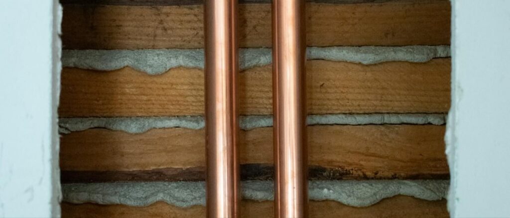 Copper supply pipes running through an open wall