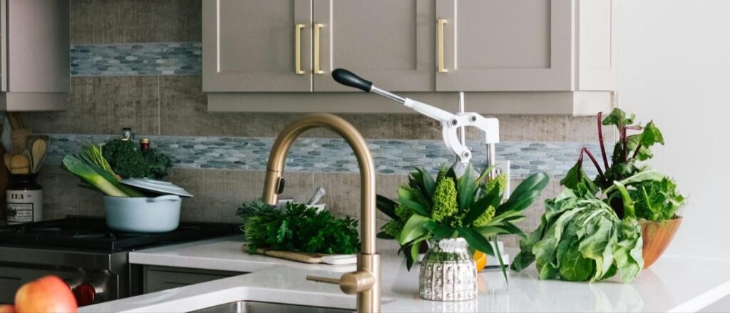 Kitchen with a brass faucet over a farmhouse sink