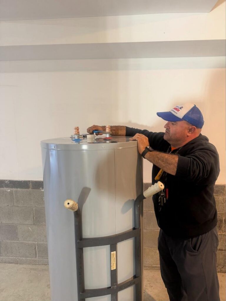 Empire plumber setting a new electric water heater