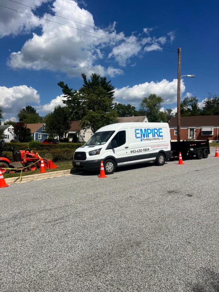 Empire van, trailer and tractor at a water line job with safety cones