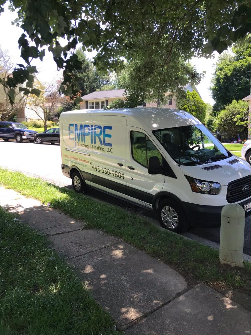 White Empire Plumbing & Heating van parked at a customer home